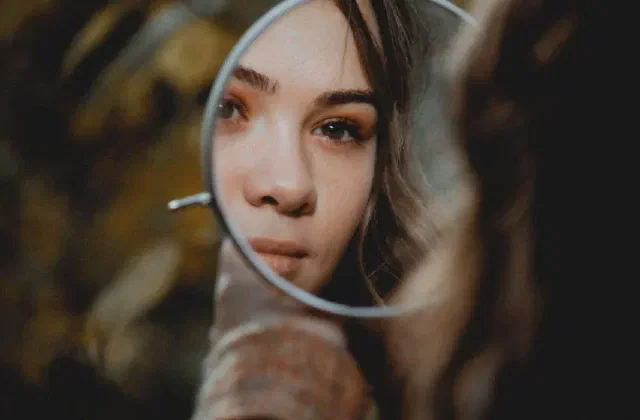 A woman looking into a mirror