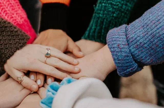 Sylibi - group of women holding hands - social enterprise manager training program - 600px